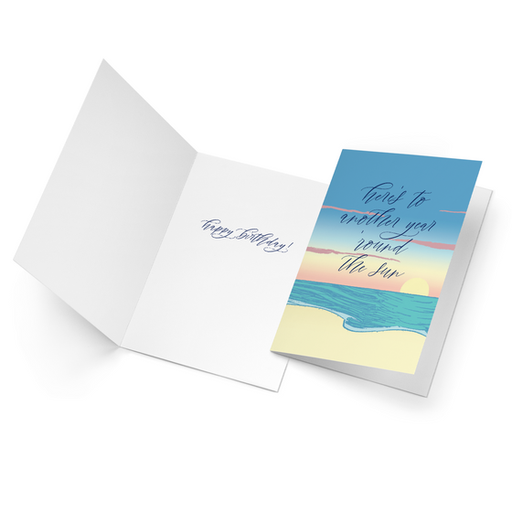 This lovely birthday card features an image of the sun setting at the beach with the message, "Here's to another year 'round the sun." Inside, the card reads, "Happy birthday!" 
